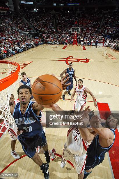 Ronnie Price of the Utah Jazz shoots a layup against Luis Scola of the Houston Rockets during the game at Toyota Center on February 16, 2010 in...