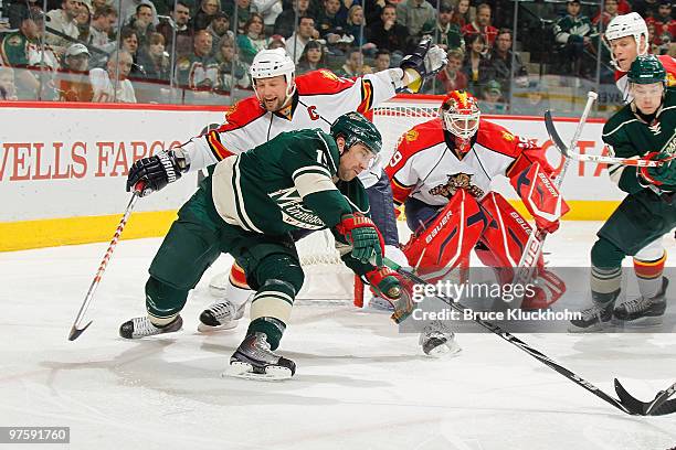 Bryan McCabe of the Florida Panthers is called for a hooking penalty against Andrew Brunette of the Minnesota Wild during the game at the Xcel Energy...