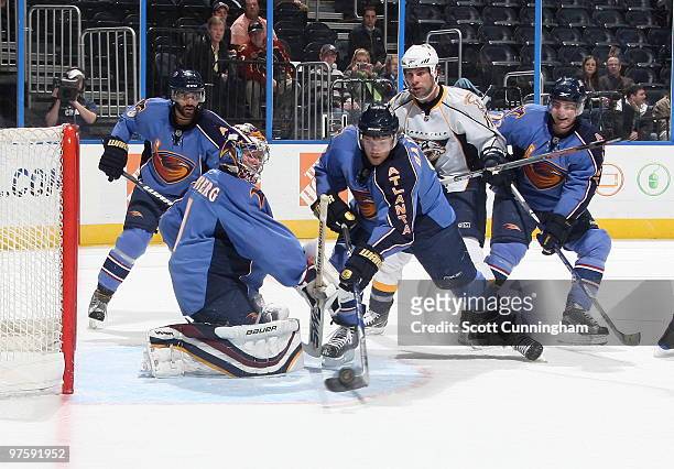 Ron Hainsey of the Atlanta Thrashers clears the puck against the Nashville Predators as goalie Johan Hedberg looks on at Philips Arena on March 9,...