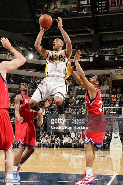 Dahntay Jones of the Indiana Pacers shoots over Willie Green and Lou Williams of the Philadelphia 76ers at Conseco Fieldhouse on March 9, 2010 in...
