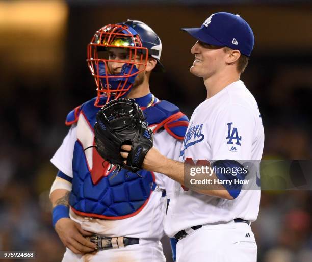 Ross Stripling of the Los Angeles Dodgers reacts with Yasmani Grandal after giving up a two run homerun to Pablo Sandoval of the San Francisco...