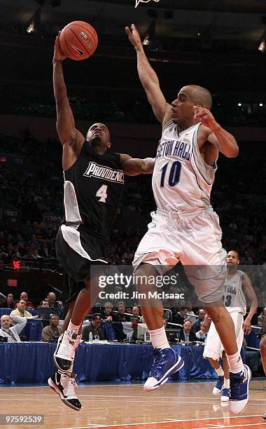 Sharaud Curry of the Providence Friars drives to the hoop against Jordan Theodore of the Seton Hall Pirates during the first round game of the Big...