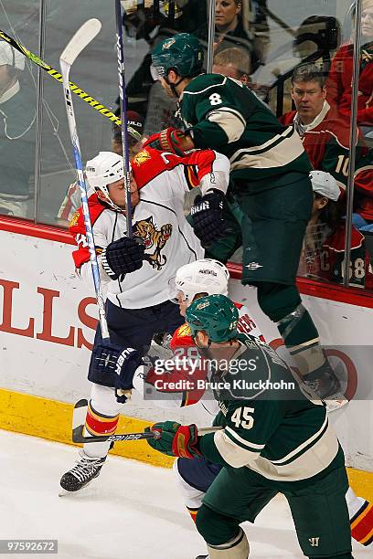 Brent Burns of the Minnesota Wild is checked by Nick Tarnasky of the Florida Panthers during the game at the Xcel Energy Center on March 9, 2010 in...