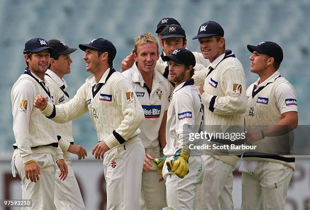 Damien Wright of the Bushrangers celebrates with his team mates after dismissing Rhett Lockyear of the Tigers during day one of the Sheffield Shield...