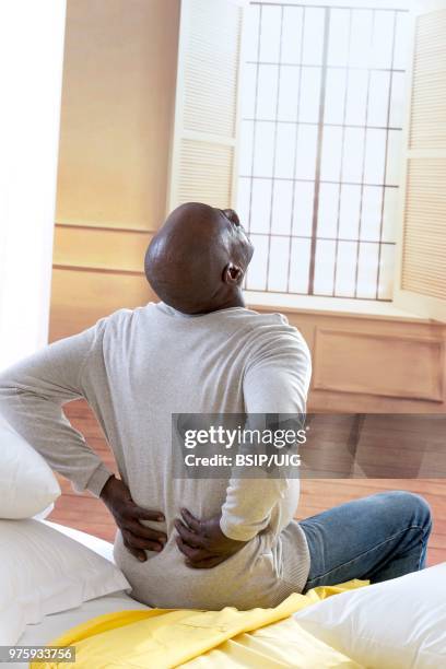 a man suffering from lower back pain. - lumbar vertebra stock pictures, royalty-free photos & images