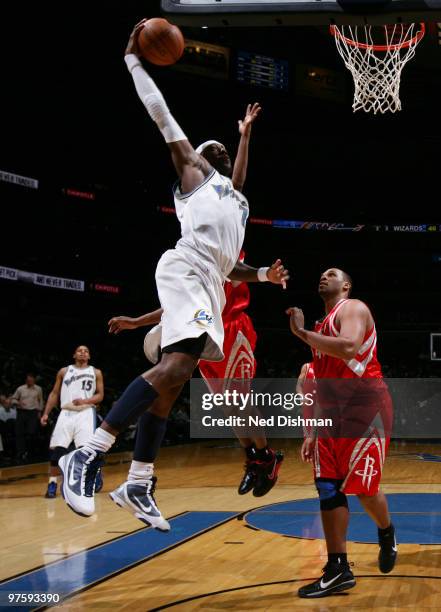 Andray Blatche of the Washington Wizards dunks against Chuck Hayes of the Houston Rockets at the Verizon Center on March 9, 2010 in Washington, DC....