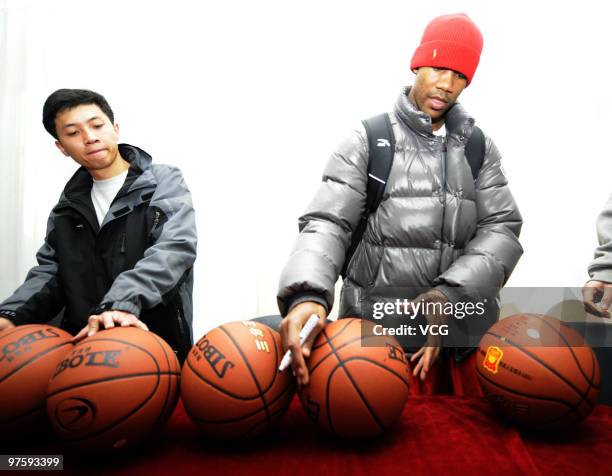 Former NBA player Stephon Marbury signs basketballs ahead of a Shanxi Zhongyu Brave Dragons CBA training session on March 9, 2010 in Taiyuan, Shanxi...