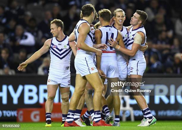 Nat Fyfe of the Dockers is congratulated by team mates after kicking a goal during the round 13 AFL match between the Carlton Blues and the Fremantle...