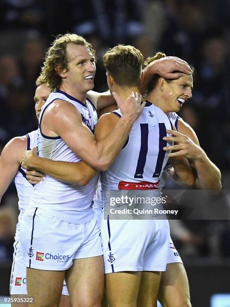Nat Fyfe of the Dockers is congratulated by team mates after kicking a goal during the round 13 AFL match between the Carlton Blues and the Fremantle...