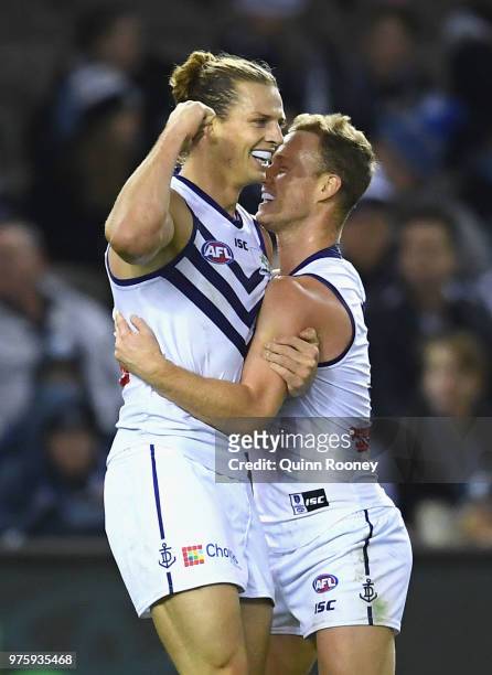 Nat Fyfe of the Dockers is congratulated by team mates after kicking a goal during the round 13 AFL match between the Carlton Blues and the Fremantle...
