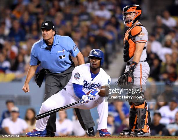 Yasiel Puig of the Los Angeles Dodgers reacts to his foul in front of Nick Hundley of the San Francisco Giants and home plate umpire Phil Cuzzi...