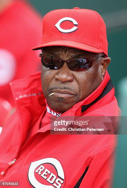 Manager Dusty Baker of the Cincinnati Reds watches from the dugout during the MLB spring training game against the Kansas City Royals at Goodyear...