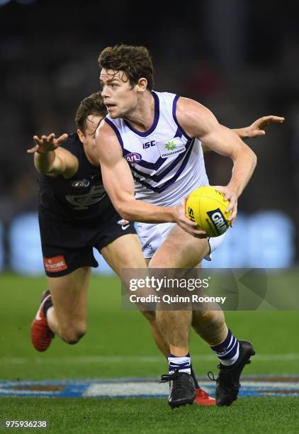 Lachie Neale of the Dockers breaks free of a tackle during the round 13 AFL match between the Carlton Blues and the Fremantle Dockers at Etihad...