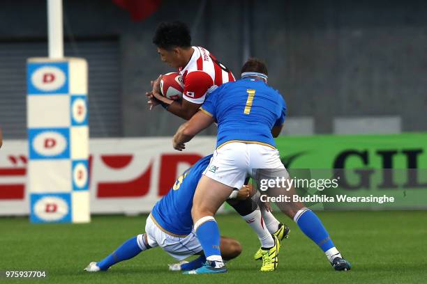 Yoshitaka Tokunaga of Japan is challenged during the rugby international match between Japan and Italy at Noevir Stadium Kobe on June 16, 2018 in...