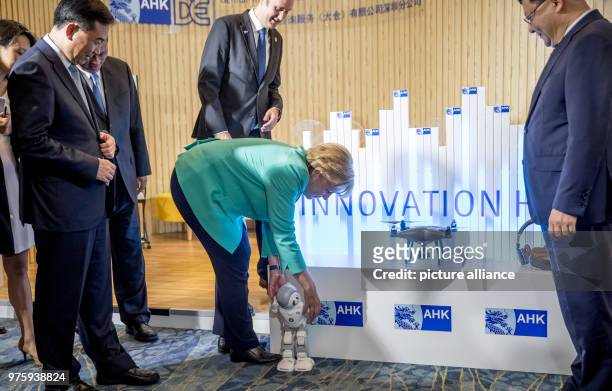 May 2018, China, Shenzhen: German Chancellor Angela Merkel of the Christian Democratic Union attends the opening of AHK- Innovation Hub Shenzhen and...