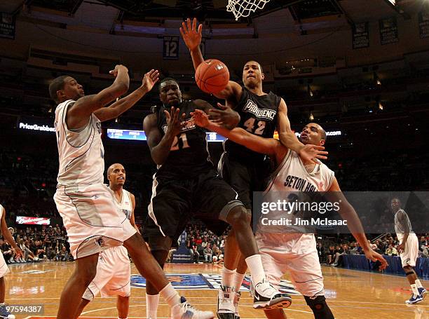 Jamine Peterson and Bilal Dixon of the Providence Friars fight for a loose ball with John Garcia of the Seton Hall Pirates during the first round...