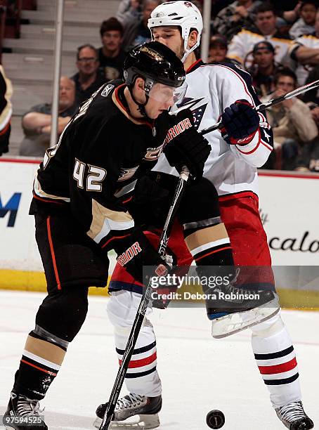 Dan Sexton of the Anaheim Ducks battles for the puck against Fedor Tyutin of the Columbus Blue Jackets during the game on March 9, 2010 at Honda...