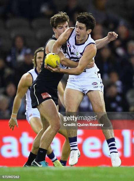 Andrew Brayshaw of the Dockers handballs whilst being tackled by Paddy Dow of the Blues during the round 13 AFL match between the Carlton Blues and...