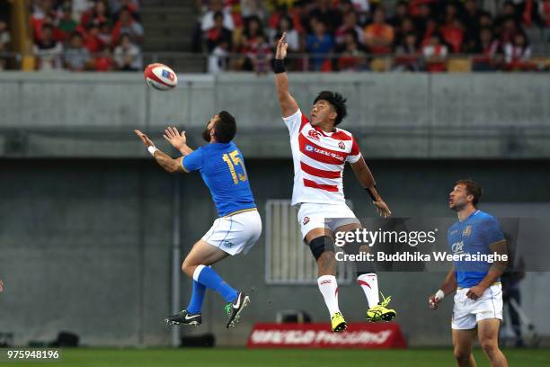 Yoshitaka Tokunaga of Japan and Jayden Hayward of Italy compete for the ball during the rugby international match between Japan and Italy at Noevir...