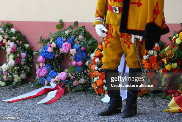 May 2018, Germany, Altshausen: A guardsman standing beside wreaths outside the church. Photo: Karl-Josef Hildenbrand/dpa