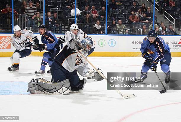 Dan Ellis of the Nashville Predators attempts to clear a rebound against Clarke MacArthur of the Atlanta Thrashers at Philips Arena on March 9, 2010...