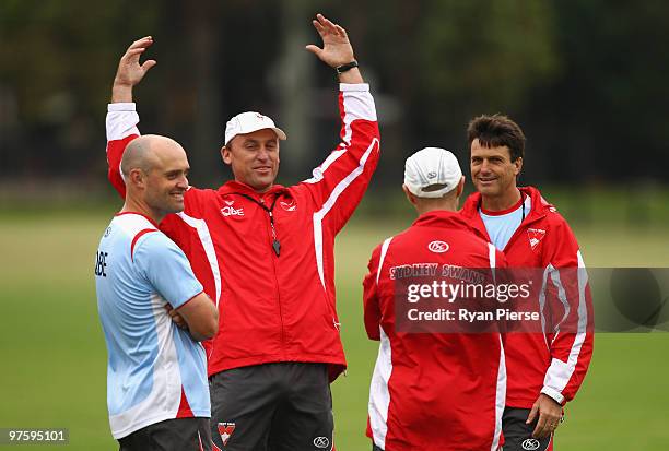 Paul Roos , coach of the Swans, speaks with John Longmire , assistant coach of the Swans, during a Sydney Swans AFL training session at Lakeside Oval...