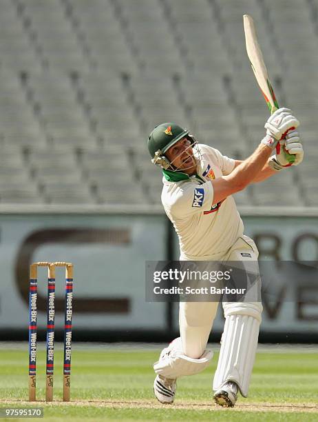 Jason Krejza of the Tigers hits a shot during day one of the Sheffield Shield match between the Victorian Bushrangers and the Tasmanian Tigers at the...