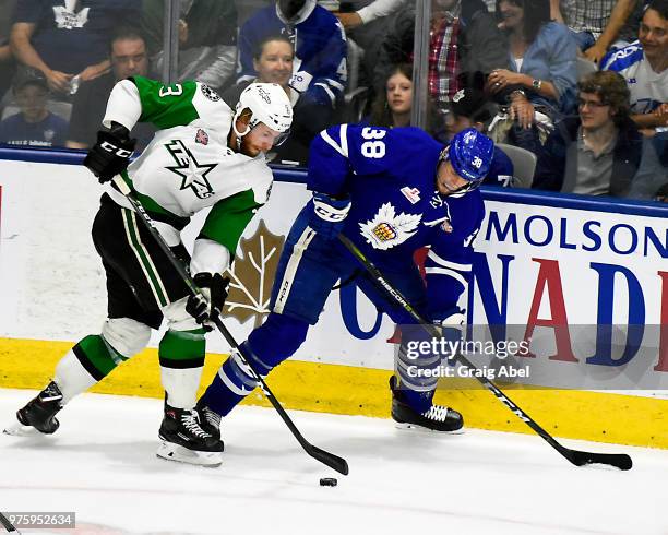 Colin Greening of the Toronto Marlies battles for the puck with Dillon Heatherington of the Texas Stars during game 6 of the AHL Calder Cup Final on...