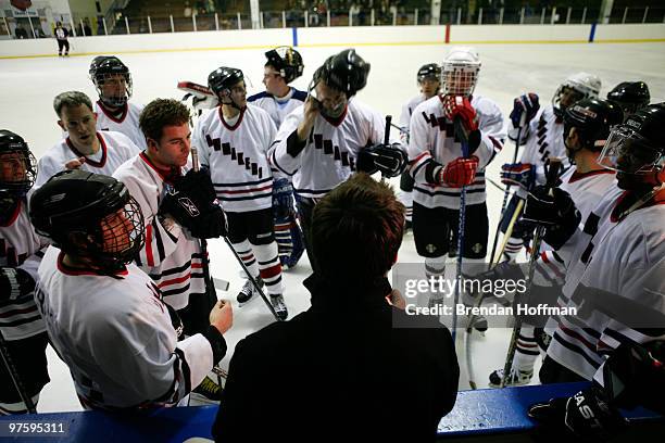 The Lawmakers hockey team gathers for a motivational talk before their game against the Lobbyists at the Congressional Hockey Challenge on March 9,...