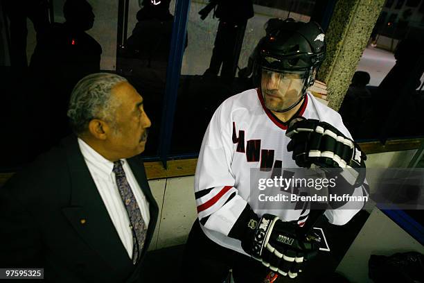 Jeff McEvoy, right, talks with Neal Henderson, founder of the Fort Dupont Ice Hockey Club, while serving time in the penalty box during the...