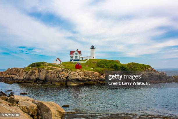 lighthouse in cape neddick under sky with clouds, york, maine, usa - york maine stock pictures, royalty-free photos & images