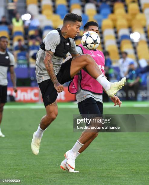 May 2018, Ukraine, Kiev: Football, Liverpool FC training: Roberto Firmino and Emre Can vie for the ball during training at the Olimpiyskiy National...