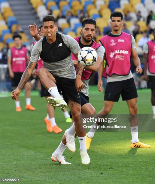 May 2018, Ukraine, Kiev: Football, Liverpool FC training: Roberto Firmino and Emre Can vie for the ball during training at the Olimpiyskiy National...