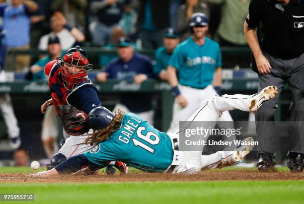 Ben Gamel of the Seattle Mariners beats the throw to Christian Vazquez of the Boston Red Sox at home to score the winning run in the eighth inning of...