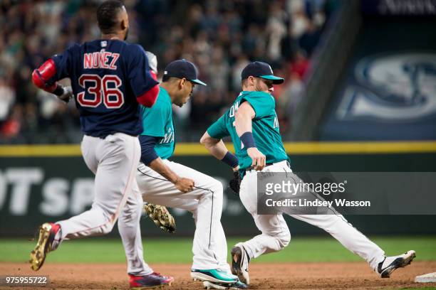 Edwin Diaz of the Seattle Mariners and Andrew Romine double up at first base to get the final out of the game against Eduardo Nunez of the Boston Red...