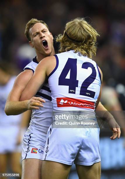 Brandon Matera of the Dockers is congratulated by Stefan Giro after kicking a goal during the round 13 AFL match between the Carlton Blues and the...