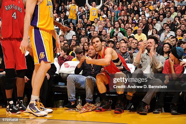 Jose Calderon of the Toronto Raptors reacts after losing the ball out of bounds due to the interference of Lapo Elkann during a game against the Los...