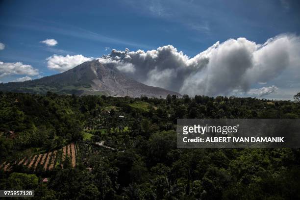 Mount Sinabung volcano spews thick volcanic ash, as seen from Karo on June 16, 2018. - Sinabung roared back to life in 2010 for the first time in 400...