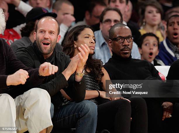 Actor Jason Statham , Maya Gilbert and actor Eddie Murphy attend a game between the Toronto Raptors and the Los Angeles Lakers at Staples Center on...