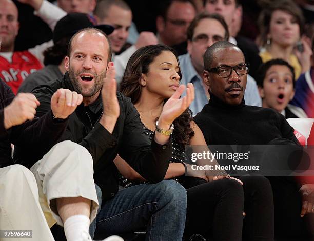 Actor Jason Statham , Maya Gilbert and actor Eddie Murphy attend a game between the Toronto Raptors and the Los Angeles Lakers at Staples Center on...