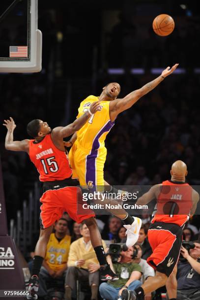 Josh Powell of the Los Angeles Lakers reaches for the ball against Amir Johnson of the Toronto Raptors at Staples Center on March 9, 2010 in Los...