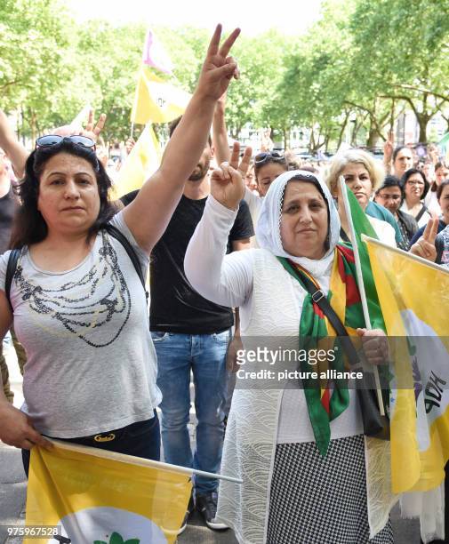 May 2018, Germany, Cologne: Two women carry flags of the Turkish opposition party HDP at a protest against Turkish President Recep Tayyip Erdogan at...