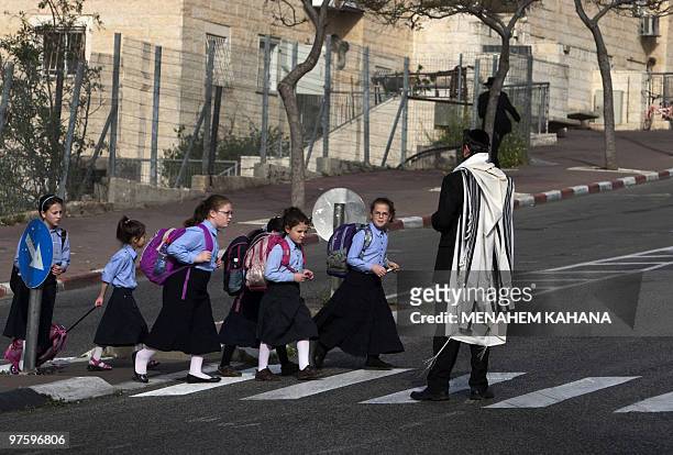 Israeli school children cross the street in Ramat Shlomo, a Jewish settlement in the mainly Arab eastern sector of Jerusalem, on March 10, 2010....