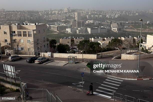 An ultra-Orthodox Jewish man walks in the Jewish settlement of Ramat Shlomo in the mainly Arab eastern sector of Jerusalem on March 10, 2010. Israel...