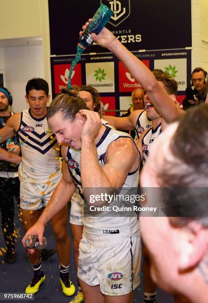 Nat Fyfe of the Dockers is sprayed with drinks in the rooms after winning the round 13 AFL match between the Carlton Blues and the Fremantle Dockers...