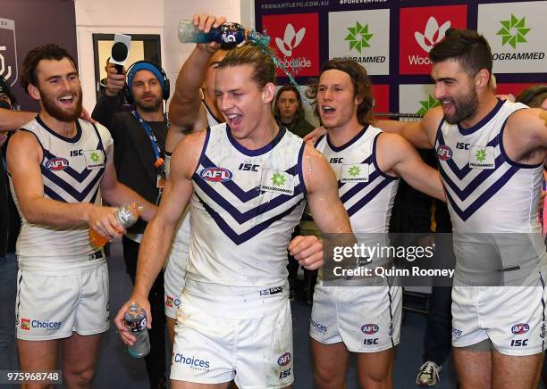 Nat Fyfe of the Dockers is sprayed with drinks in the rooms after winning the round 13 AFL match between the Carlton Blues and the Fremantle Dockers...