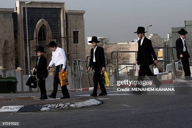 Jewish youths cross a street in Ramat Shlomo, a Jewish settlement in the mainly Arab eastern sector of Jerusalem, on March 10, 2010. Israel approved...