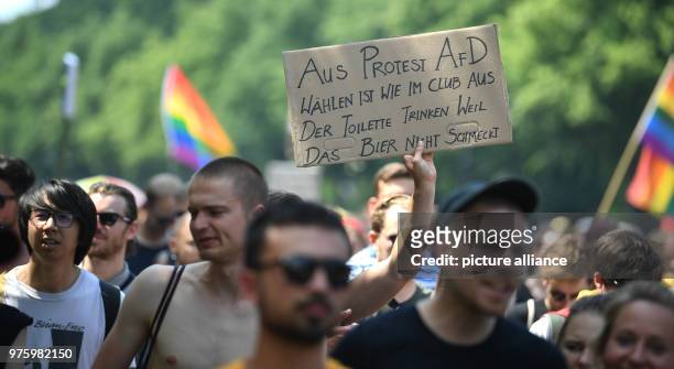 May 2018, Germany, Berlin: A protestor holds up a sign reading 'Aus Protest AfD waehlen ist wie im Club aus der Toilette trinken weil das Bier nicht...