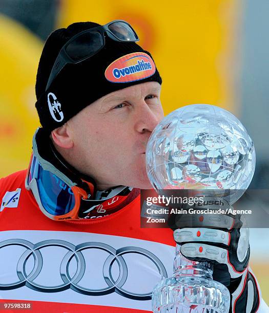 Didier Cuche of Switzerland takes the globe for the overall World Cup Downhill during the Audi FIS Alpine Ski World Cup Men's Downhill on March 10,...