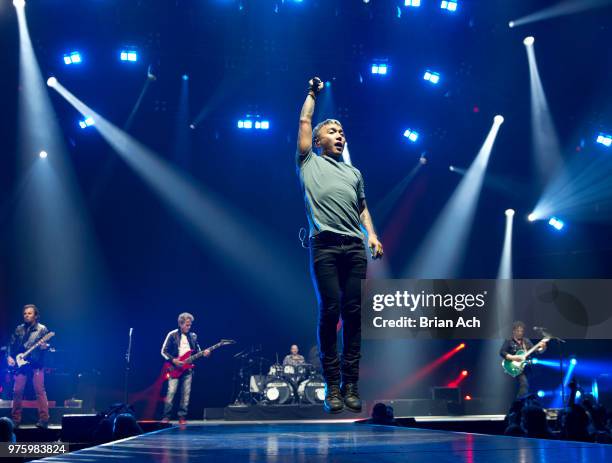 Keyboardist Jonathan Cain, bassist Ross Valory, singer Arnel Pineda, drummer Steve Smith, and founder and guitarist Neal Schon of the band Journey...